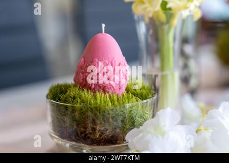 Colorful easter egg soy wax candle. Spring background Stock Photo