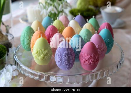 Colorful easter egg soy wax candles. Spring background Stock Photo