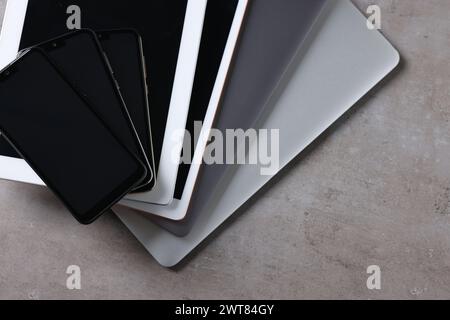 Many different modern gadgets on grey table, closeup Stock Photo