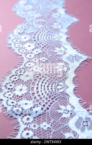 White lace on purple background, closeup view Stock Photo