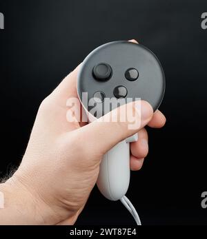 Close up of joystick in hand isolated on black studio background Stock Photo