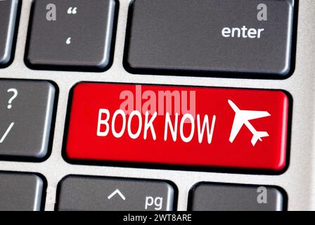 Book now text on red keyboard. Traveling concept Stock Photo