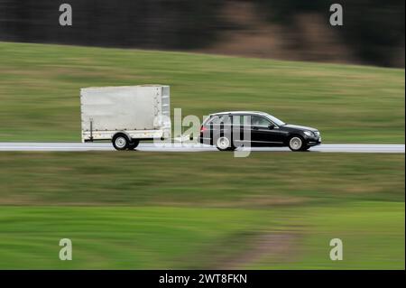 SYMBOL - 16 March 2024, Baden-Württemberg, Rottweil: A Mercedes with a trailer drives on the B27 federal highway near Rottweil. (Shot with longer exposure time). Photo: Silas Stein/dpa Stock Photo