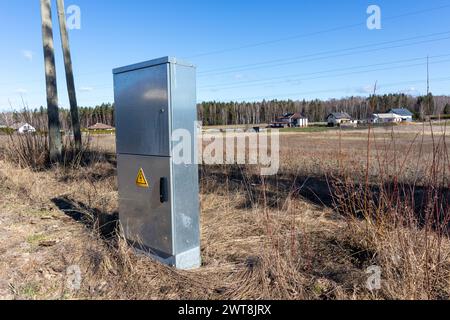 Metal electrical distribution box on field background Stock Photo