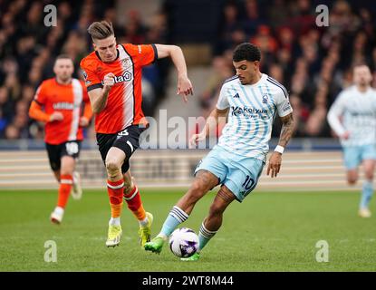 Luton Town's Reece Burke (left) and Nottingham Forest's Morgan Gibbs-White in action during the Premier League match at Kenilworth Road, Luton. Picture date: Saturday March 16, 2024. Stock Photo