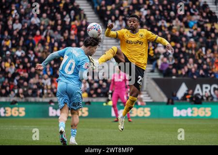 Wolverhampton, UK. 16th Mar, 2024. Wolverhampton, England, March 16th 2024: Callum O'Hare (10 Coventry City) header as Nelson Semedo (22 Wolves) jumps for the ball during the FA Cup football match between Wolverhampton Wanderers and Coventry City at Molineux stadium in Wolverhampton, England (Natalie Mincher/SPP) Credit: SPP Sport Press Photo. /Alamy Live News Stock Photo