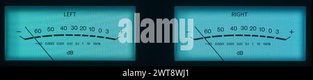 Audio Dual Volume Unit Meters Glowing in the Dark with Teal Hues. Stock Photo