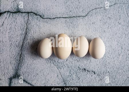 Four white eggs on an empty background. Easter concept Stock Photo