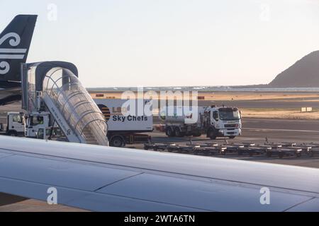 Wellington, New Zealand - February 21, 2024: Air New Zealand on the tarmac at Wellington Interntational Airport refuelling and loading passenger meals Stock Photo