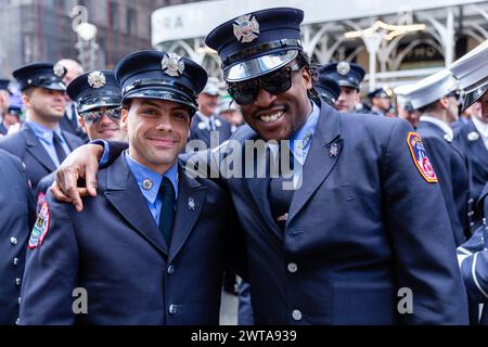 New York, NY, USA. 16th Mar, 2024. Irish-American contingents kicked off New York's St. Patrick's Day Parade to the tunes of numerous pipe bands, and cheered on by throngs of spectators, many bedecked in green. Two New York firefighters pose for a photo. Credit: Ed Lefkowicz/Alamy Live News Stock Photo