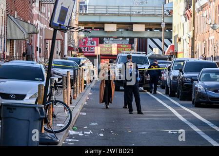 Philadelphia, United States. 16th Mar, 2024. Police block off roads and gather evidence as they investigate a shooting near the Kensington area in Philadelphia. One person was killed and one person wounded in a double shooting on East Lippincott Street in Philadelphia. A 25-year-old Hispanic male died from a gunshot wound to the chest and a 23-year-old Hispanic female was wounded by a graze wound to the left arm and is in stable condition. The shooting happened at approximately 3:27 PM, Saturday afternoon. (Photo by Kyle Mazza/SOPA Images/Sipa USA) Credit: Sipa USA/Alamy Live News Stock Photo