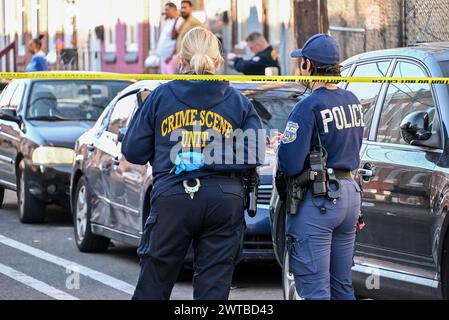 Philadelphia, United States. 16th Mar, 2024. Police block off roads and gather evidence as they investigate a shooting near the Kensington area in Philadelphia. One person was killed and one person wounded in a double shooting on East Lippincott Street in Philadelphia. A 25-year-old Hispanic male died from a gunshot wound to the chest and a 23-year-old Hispanic female was wounded by a graze wound to the left arm and is in stable condition. The shooting happened at approximately 3:27 PM, Saturday afternoon. (Photo by Kyle Mazza/SOPA Images/Sipa USA) Credit: Sipa USA/Alamy Live News Stock Photo