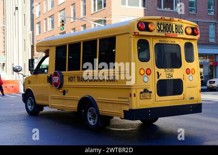 Backside of a yellow school bus with extended stop sign in city traffic, downtown Manhattan, Manhattan, New York City, USA, North America Stock Photo