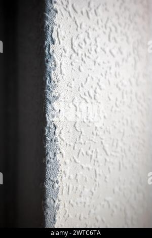 grey painted woodchip wallpaper texture pattern backgroung. Stock Photo