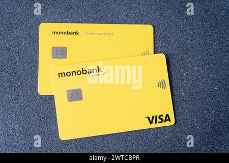 Credit card of the Ukrainian bank Monobank from Universal Bank. Yellow Visa card with chip. Ukraine, Kyiv - March 17, 2023. Stock Photo