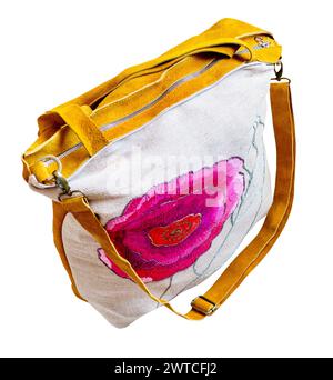 hand crafted yellow suede and canvas bag with embroidered flower cutout on white background Stock Photo