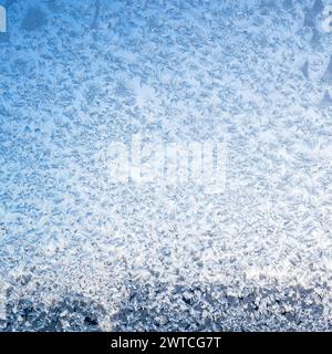 frost on home window glass and blue sky on background on cold winter twilight Stock Photo