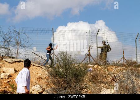 Bilin, Ramallah, Palestine. 7th Jan, 2011. Palestinian activist show his middle finger to IDF soldier during weekly Friday demonstrations against occupation of Palestinian territoriesÂ by Israel in Bilin, West Bank, Palestine on December 31, 2010. Bilin, a small village near Ramallah holds weekly protests as much of the local farmers' land was annexed by Israeli authorities to build a new Jewish settlement. (Credit Image: © Dominika Zarzycka/SOPA Images via ZUMA Press Wire) EDITORIAL USAGE ONLY! Not for Commercial USAGE! Stock Photo