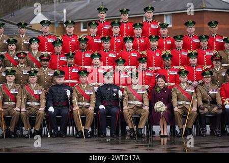 Regimental Lieutenant Colonel, Major General Sir Christopher Ghika, (fifth left) and his wife, Lady Ghika, posing with members of the Irish Guards for a family picture at Mons Barracks, Aldershot, following a St Patrick's Day parade. Picture date: Sunday March 17, 2024. Stock Photo