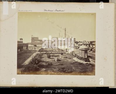 Delhi; The Jumma Musjid, from the North. Samuel Bourne, photographer (English, 1834 - 1912) about 1866 View of the Jama Masjid, a large mosque complex with two minarets, large domes, and a flight of steps that leads down from its gate to the street level. Visible in the foreground is an enclosed garden, part of an adjacent building. Also visible are a number of people dressed in traditional garments, engaged in various activities. (Recto, print) upper right, inscribed in the negative: '1354'; Lower right, inscribed in the negative, in a different hand: '1354'; (Recto, mount) upper left, in pen Stock Photo