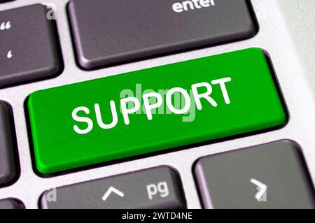 Support text on laptop keyboard button. After service support concept. Stock Photo