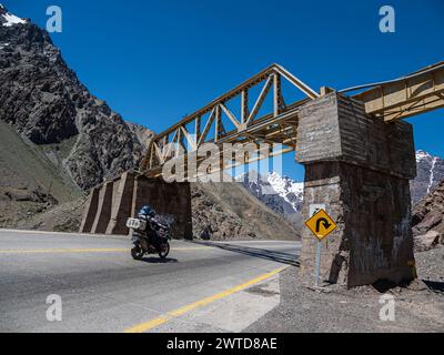 Motorcycle driving on mountain pass Los Caracoles, The Snails, road connecting Chile and Argentina, aerial view, Chile Stock Photo