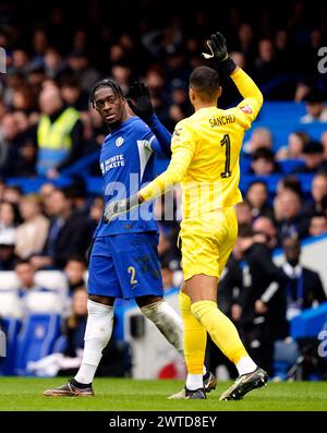 Chelsea goalkeeper Robert Sanchez with Axel Disasi after he scores an own goal for Leicester City's first goal during the Emirates FA Cup quarter-final match at Stamford Bridge, London. Picture date: Sunday March 17, 2024. Stock Photo