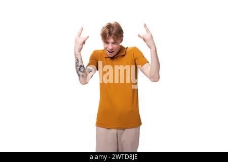 young confused student man with short red hair dressed in yellow t-shirt Stock Photo
