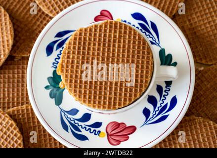 Delicious dutch Stroopwafel on the top of the coffee cup, typical sweet treat from The Netherlands, top down view Stock Photo