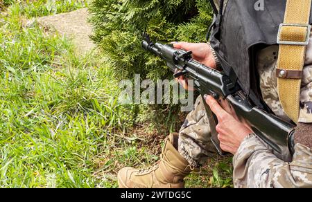 Soldier's hands hold a machine gun. Stock Photo
