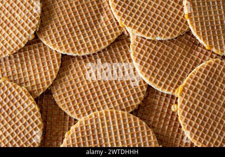 Traditional dutch Stroopwafels spread on the table, texture of  round waffle cookie, top down view Stock Photo