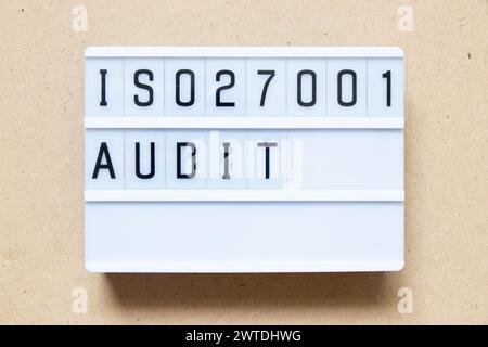Lightbox with word ISO 270001 audit on wood background Stock Photo