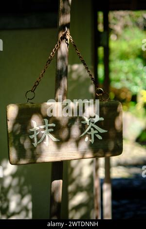 Traditional wooden sign with japanese letters at the village of ...
