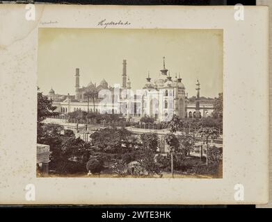 Lucknow; View from the Terrace of the Hooseinabad Emambara. Samuel Bourne, photographer (English, 1834 - 1912) 1864–1865 View of the tomb of Zinat Algiya in the Hussainabad Imambara complex, also known as Chota Imambara, an ornately decorated building of Islamic architecture with multiple domes and niches, and flanked by three visible minarets. The view is seen from an elevated vantage point on the opposite side of the reflecting pool that runs through the center of the complex. Visible in the background is the Jama Masjid, a large mosque with two visible domes and two minarets that lack top g Stock Photo