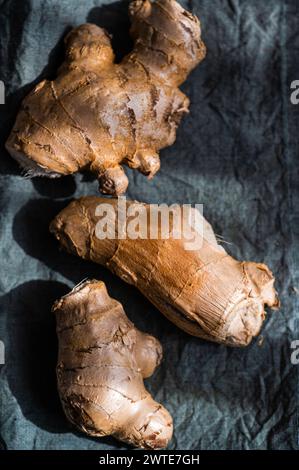 Raw organic ginger roots on textile napkin in sunny day Stock Photo