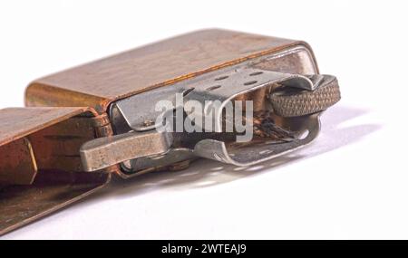 Used vintage metal lighter isolated on a white background Stock Photo