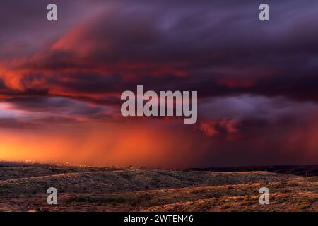 Stormy sunset sky with dark, dramatic clouds and rain in the desert near Rio Verde, Arizona Stock Photo