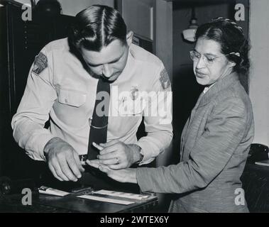 Rosa Parks being fingerprinted on February 22, 1956, after being arrested for not giving up her seat on the bus to a white person  Montgomery bus boycott. Stock Photo