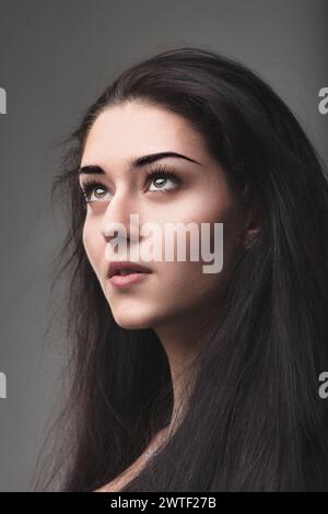 Intense gaze of a woman suggests contemplation and profound inner strength Stock Photo