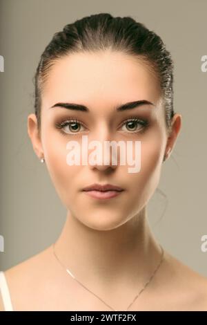 There's a tranquil depth in woman's gaze, suggesting layers of unspoken narrative Stock Photo