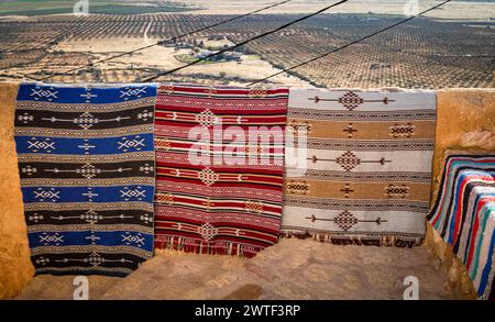 Traditional hand-woven woollen rugs in the ancient hilltop Berber village of Takrouna, Tunisia Stock Photo