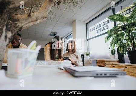 A diverse team working together on business growth, analyzing statistics and brainstorming creative marketing strategies in a successful startup. Stock Photo