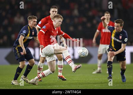 EINDHOVEN - (l-r) Michal Sadilek of FC Twente, Jerdy Schouten of PSV, Mathias Kjolo of FC Twente during the Dutch Eredivisie match between PSV Eindhoven and FC Twente at the Phillips stadium on March 17, 2024 in Eindhoven, Netherlands. ANP MAURICE VAN STEEN Stock Photo