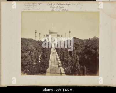 Agra; The Taj and Garden, from the Entrance Gate. Samuel Bourne, photographer (English, 1834 - 1912) 1865–1866 View of the Taj Mahal with a reflecting pool and garden in the foreground, as seen from an elevated vantage point. Three men can be seen by the pool. (Recto, print) lower center, inscribed in the negative: '1075'; (Recto, mount) upper left, in pencil: 'Tomb of Akbar's wife / The Tajje Mah [incomplete, crossed out] / Pearl of Pearls / The Tarje Mahal'; Upper center, in purple ink, blue ink, and pencil, in different hands: 'Tomb of Akbar's Wife ['Akbar's Wife' crossed out] Shah Jahan / Stock Photo