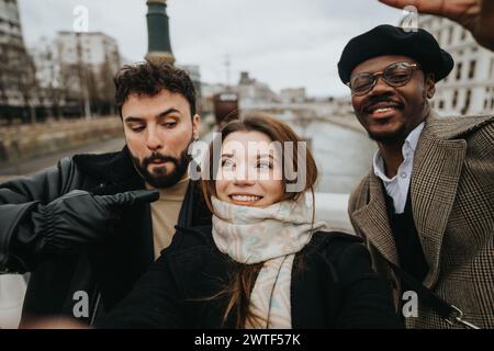 A multiethnic group of young business partners enjoying a casual moment, taking a selfie together in a city setting. Stock Photo