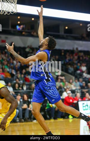 London, Canada. 17th Mar, 2024. London Ontario Canada. March 17 2024, The London Lightning defeat the Kitchener Titans 118-114 in regulation on St. Patrick's Day.Curtis Hollis (0) of Kitchener Titans goes for rebound. Credit: Luke Durda/Alamy Live News Stock Photo