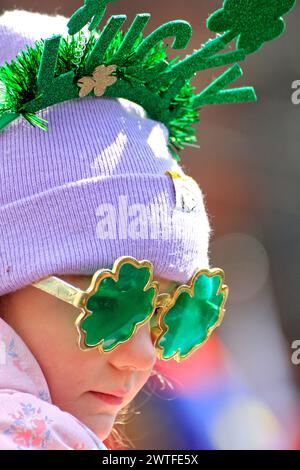 Toronto, Canada. 17th Mar, 2024. A spectator is watching the St. Patrick's Day Parade along Bloor Street in downtown Toronto, Canada, on March 17, 2024. (Photo by Mike Campbell/NurPhoto) Credit: NurPhoto SRL/Alamy Live News Stock Photo