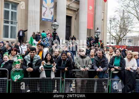 London, UK. 17th Mar, 2024. Crowds of people wearing green are seen on the side of the celebration parade route at St Patrick's Day in London. Thousands of people dress in green and join the annual celebration for St Patrick's Day Parade in central London. St Patrick's Day, or the Feast of Saint Patrick, is a religious and cultural Irish holiday held on the traditional death date of Saint Patrick on 17th March. Credit: SOPA Images Limited/Alamy Live News Stock Photo