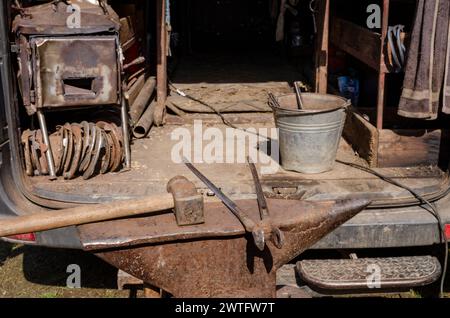 the blacksmith's anvil and tools, iron work, horseshoes, file pliers, hand tools Stock Photo