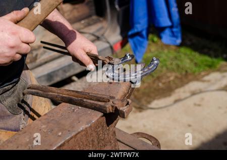 blacksmith, horseshoes a horse, a traditional job passed down from master to apprentice Stock Photo